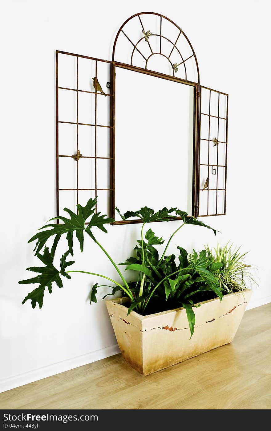 Beautiful mirror with flowerpot in the corridor