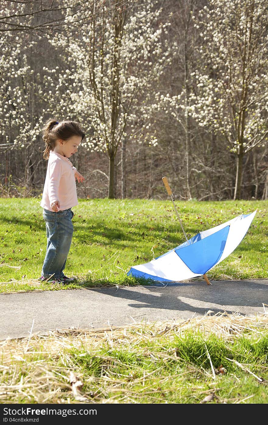 Small child playing with an umbrella