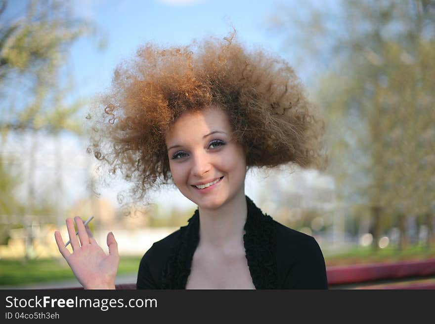 Pretty curly posing in park