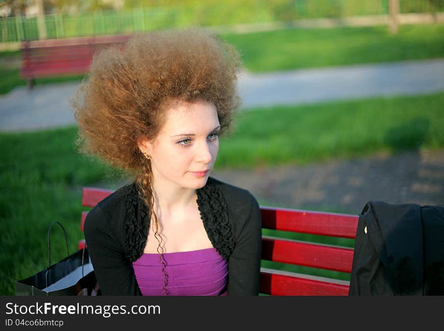 Portrait of pretty redhead girl in the park