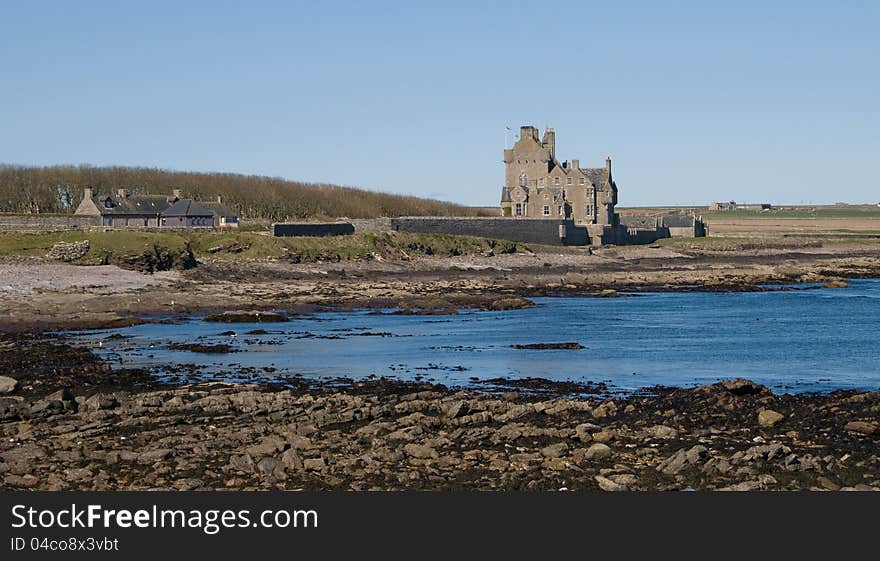 Auchergill Tower, Sinclair Bay, Caithness, Scotland,UK. Taken from the Beach. Ackergill Tower &#x28;or Ackergill Castle&#x29; is located on the coast of Sinclair&#x27;s Bay, about 4 km north of Wick, Caithness, in northern Scotland. It was built in the early 16th century and is a category A listed building. The building is a five-storey oblong tower house. The four-storey wing to the rear was added in the early 18th century. Auchergill Tower, Sinclair Bay, Caithness, Scotland,UK. Taken from the Beach. Ackergill Tower &#x28;or Ackergill Castle&#x29; is located on the coast of Sinclair&#x27;s Bay, about 4 km north of Wick, Caithness, in northern Scotland. It was built in the early 16th century and is a category A listed building. The building is a five-storey oblong tower house. The four-storey wing to the rear was added in the early 18th century.