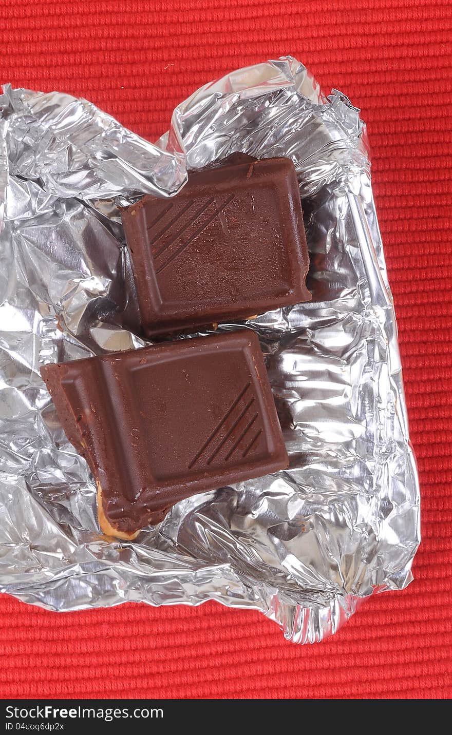 Broken chocolate on aluminum foil cover