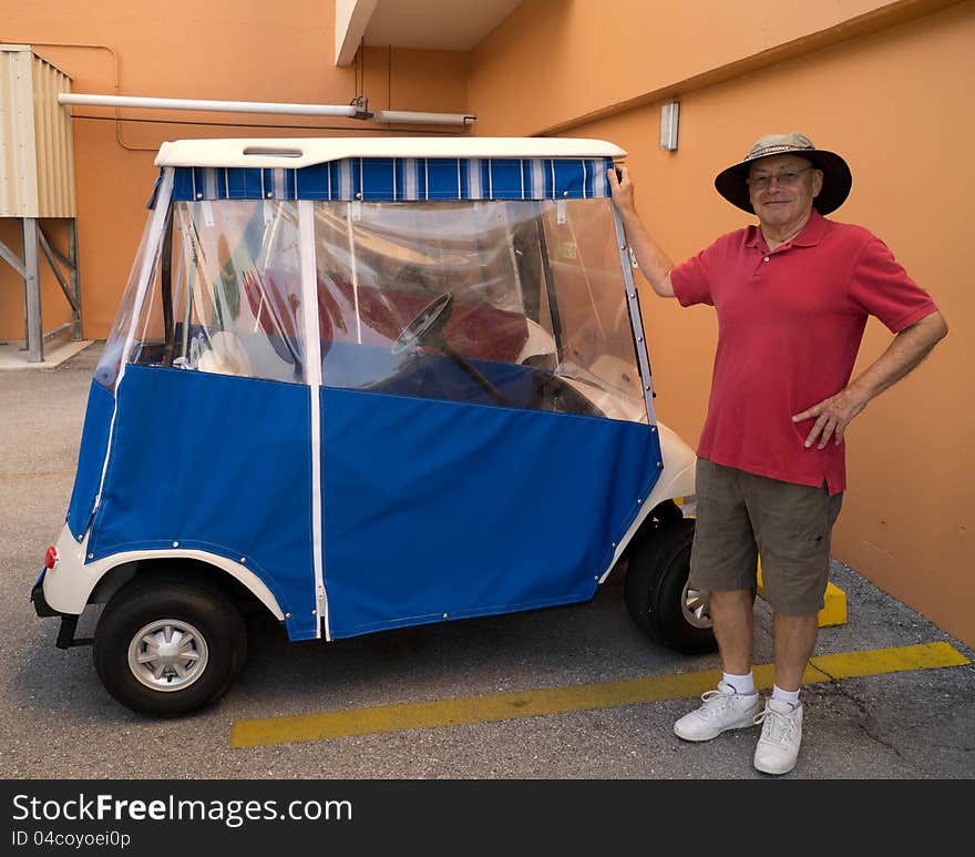 A retired senior citizen man shows off his brand new golf cart at a retirement village in Florida. Toys for boys at any age. A retired senior citizen man shows off his brand new golf cart at a retirement village in Florida. Toys for boys at any age.