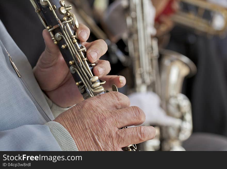 Hands playing a pipe