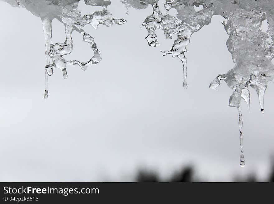 Thawing Icicles against a blue sky. Abstract form. Thawing Icicles against a blue sky. Abstract form.