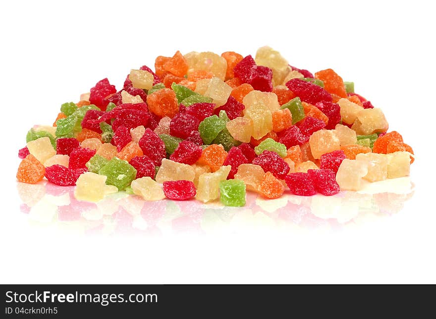 A handful of colorful sweet candied fruit on a white background. A handful of colorful sweet candied fruit on a white background