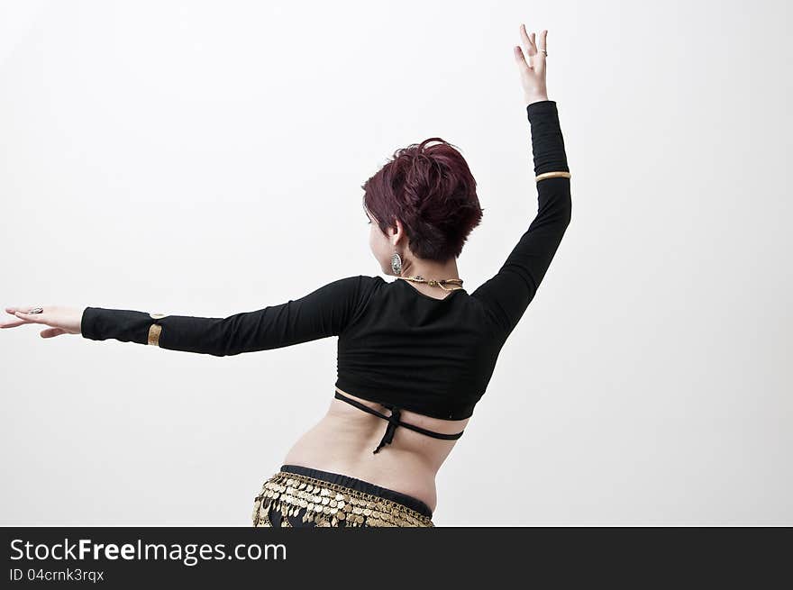 Beautiful tribal dancer with oriental ornament photographed on white background. Beautiful tribal dancer with oriental ornament photographed on white background