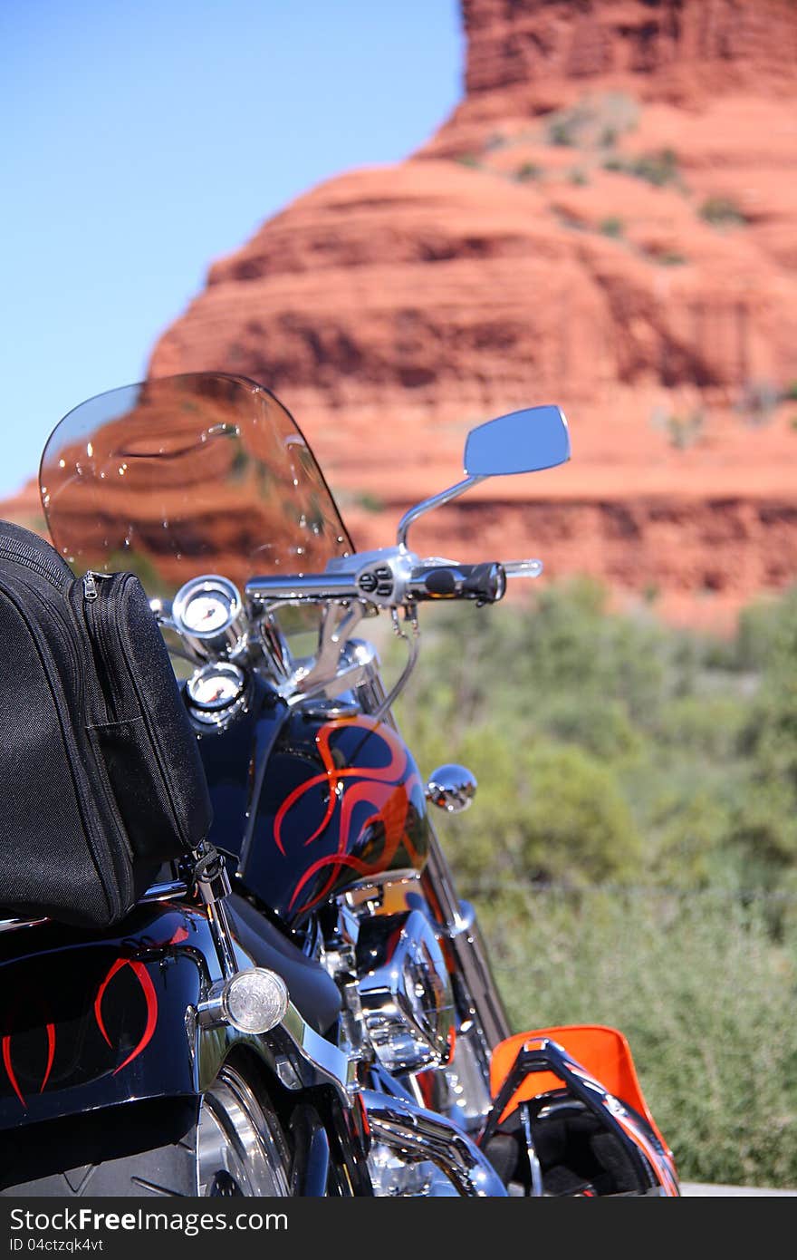 Ride a motorcycle acrossing the street of Arizona (Bell Rock in Village of Oak Creek). Ride a motorcycle acrossing the street of Arizona (Bell Rock in Village of Oak Creek)