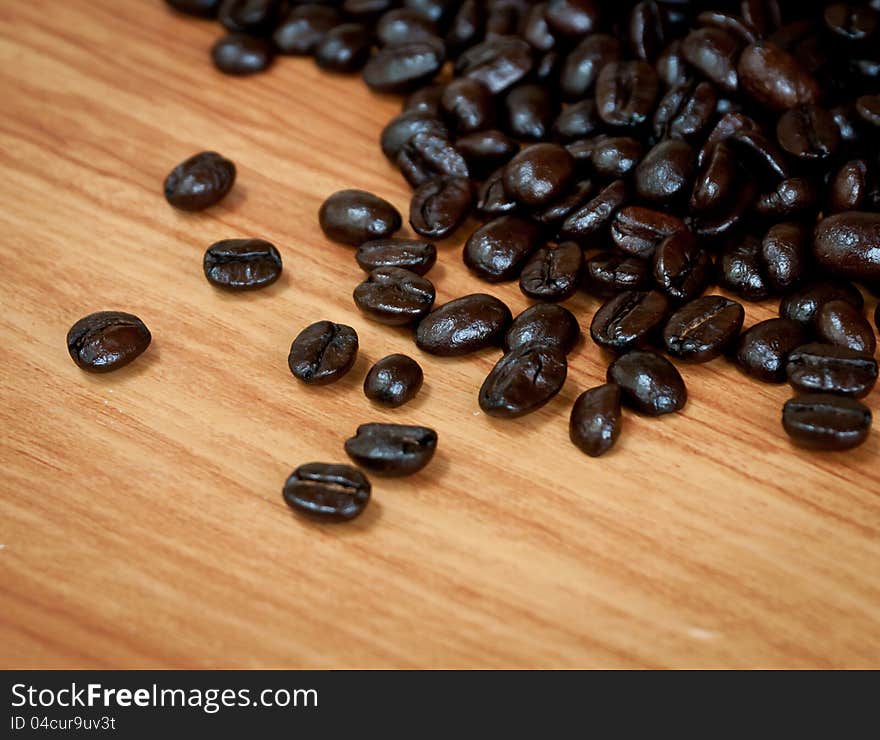 Roasted coffee  beans  on wood texture. Roasted coffee  beans  on wood texture.