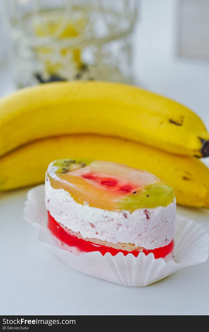 Fruitcake and bananas on a white table