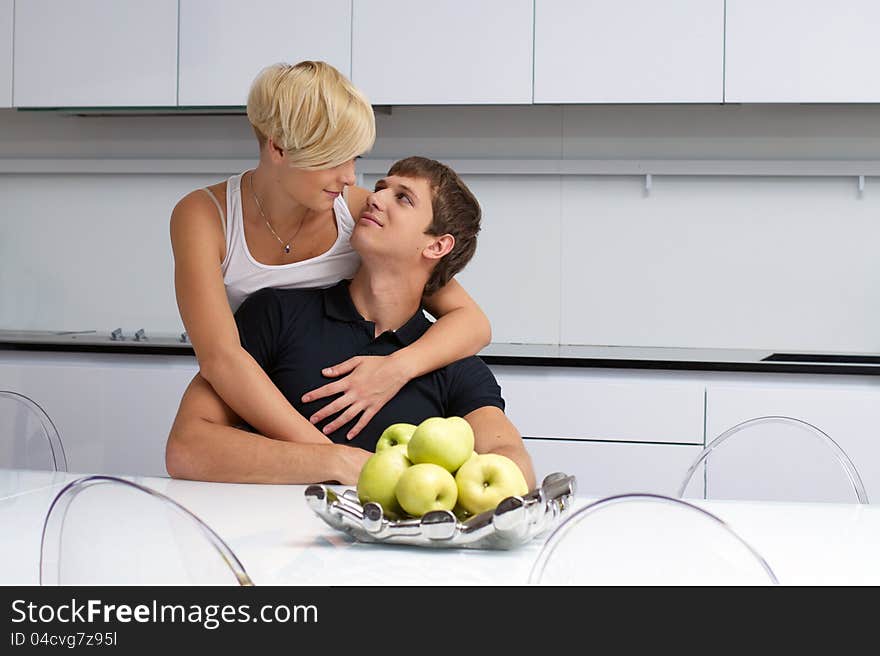 Happy couple posing in the kitchen