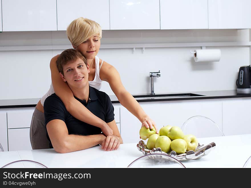 Portrait of a happy couple posing in the kitchen