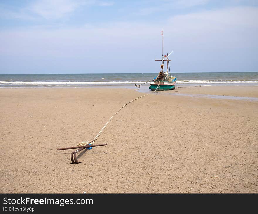 A fishing boat anchored by the beach