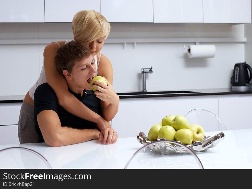 Happy couple posing in the kitchen