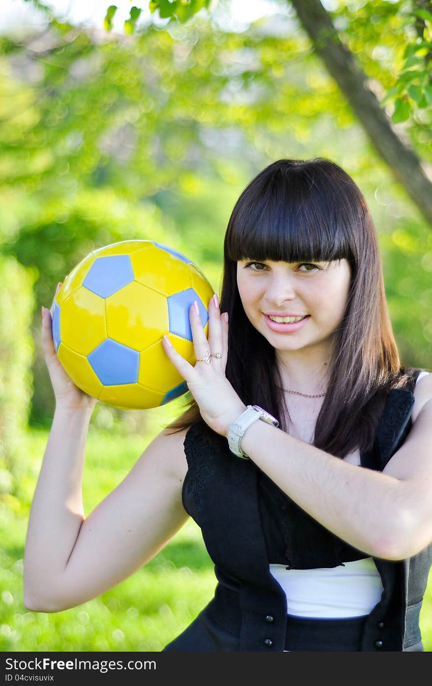 Beautiful Ukrainian girl with a ball in the colors of national flag inviting to Euro 2012