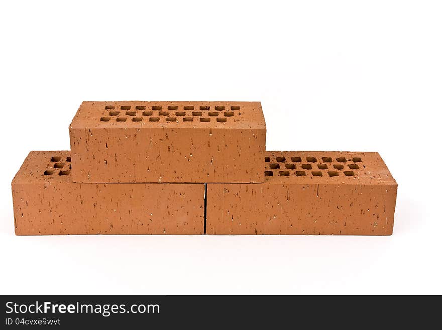 Three bricks on a white background shown.