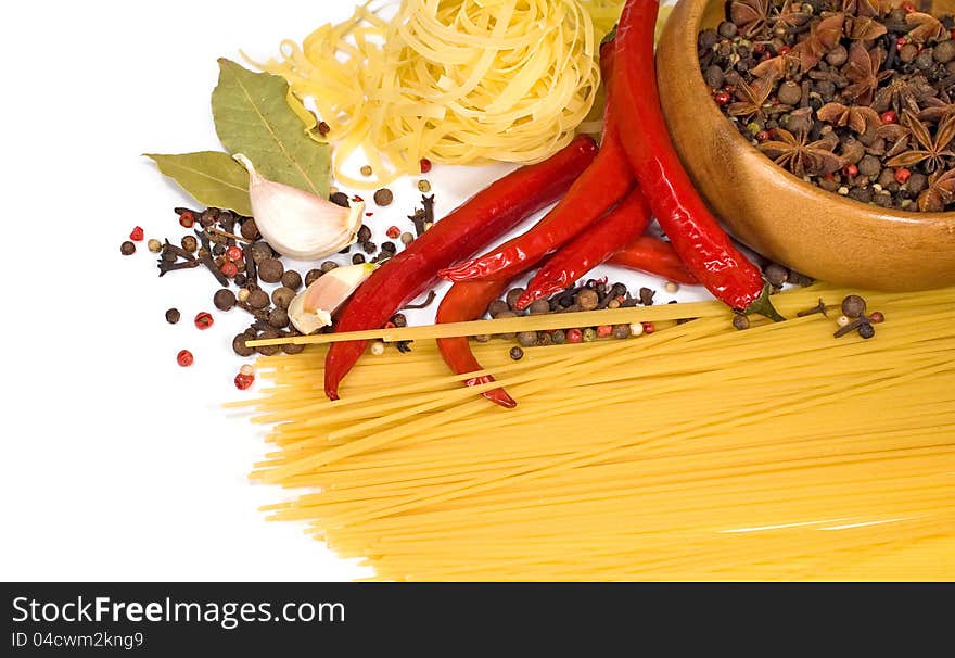 Food: spaghetti, spices and peppers on a white background