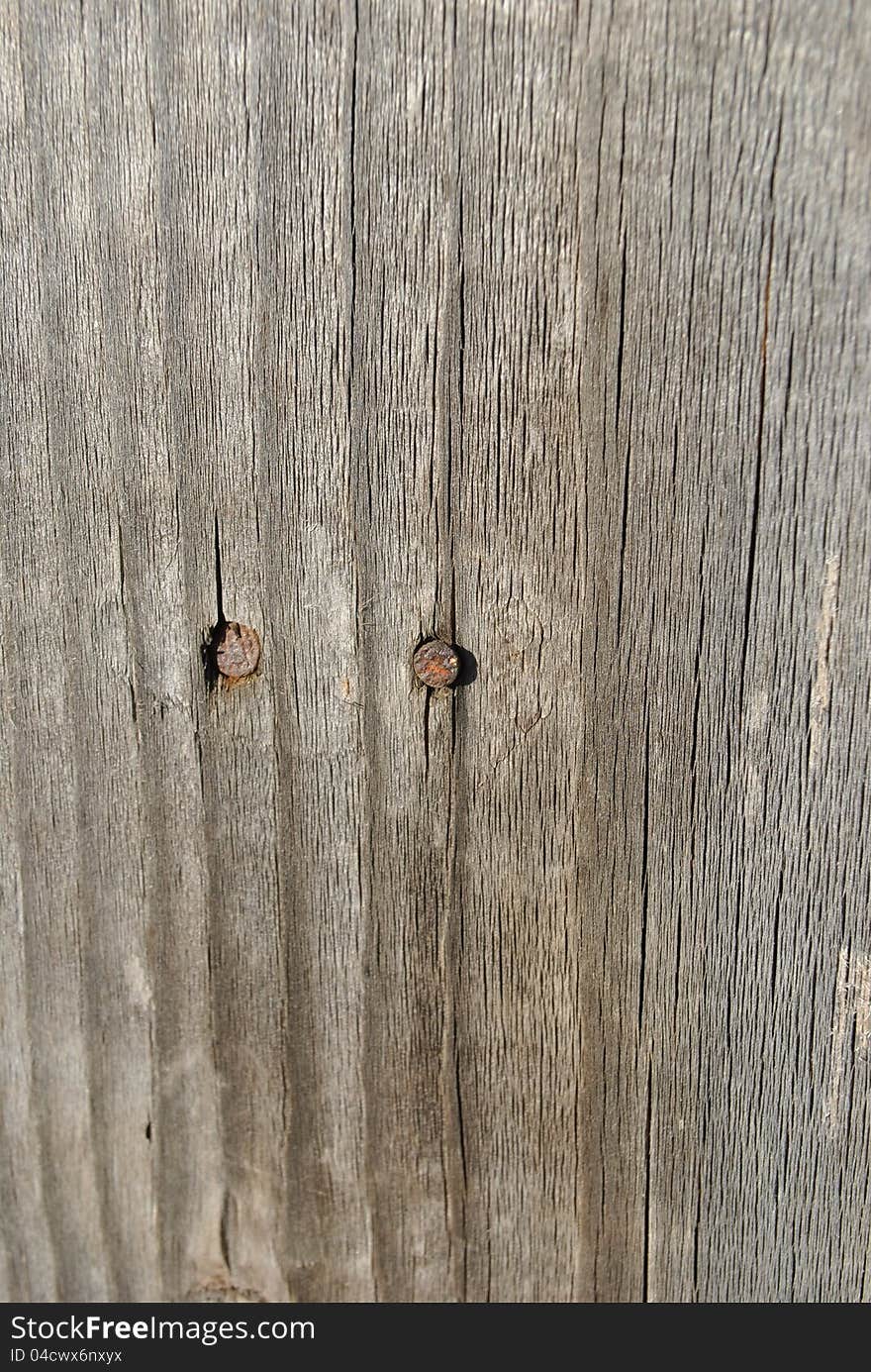 Image of a wood plank with two nails. Image of a wood plank with two nails