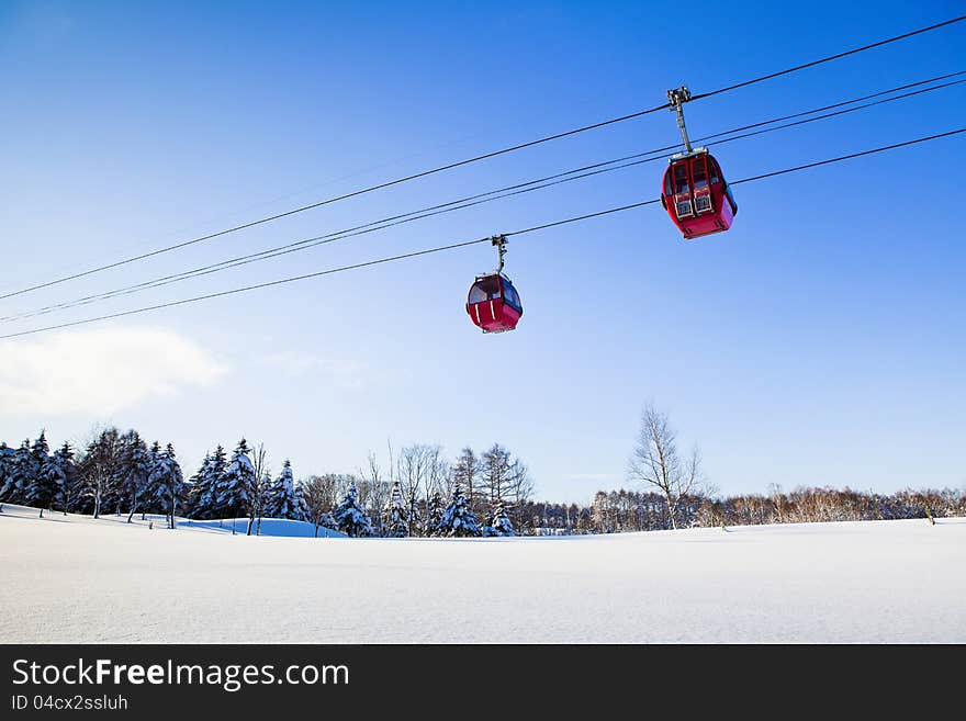 Two red cable car in winter