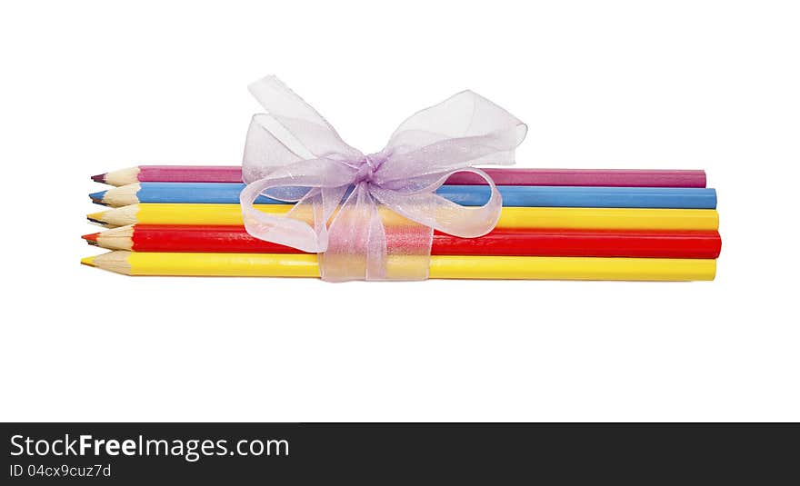 Crayons tied with lilac ribbon on white background. Crayons tied with lilac ribbon on white background