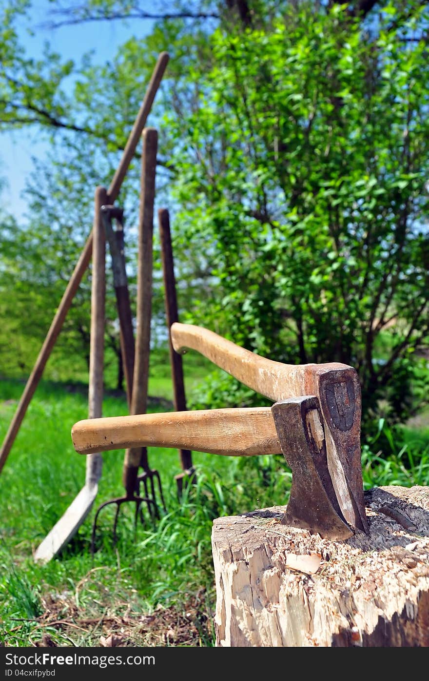 Two axes stuck in a wooden chopping block. Two axes stuck in a wooden chopping block