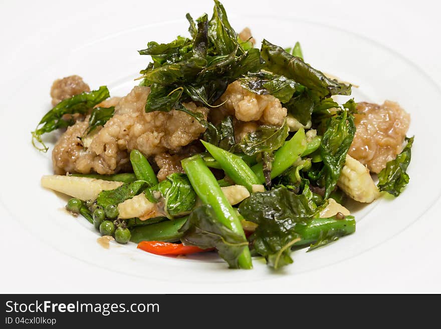 Wok fried chicken, fresh green peppercorns, long bean, baby corn and hot basil. Wok fried chicken, fresh green peppercorns, long bean, baby corn and hot basil