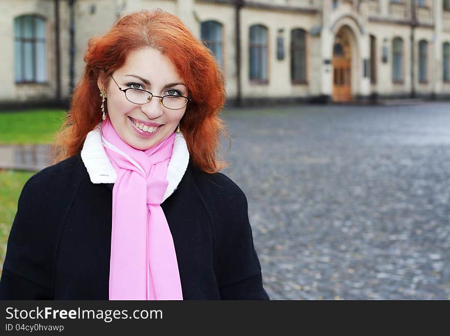 Portrait of red haired girl in front of the university