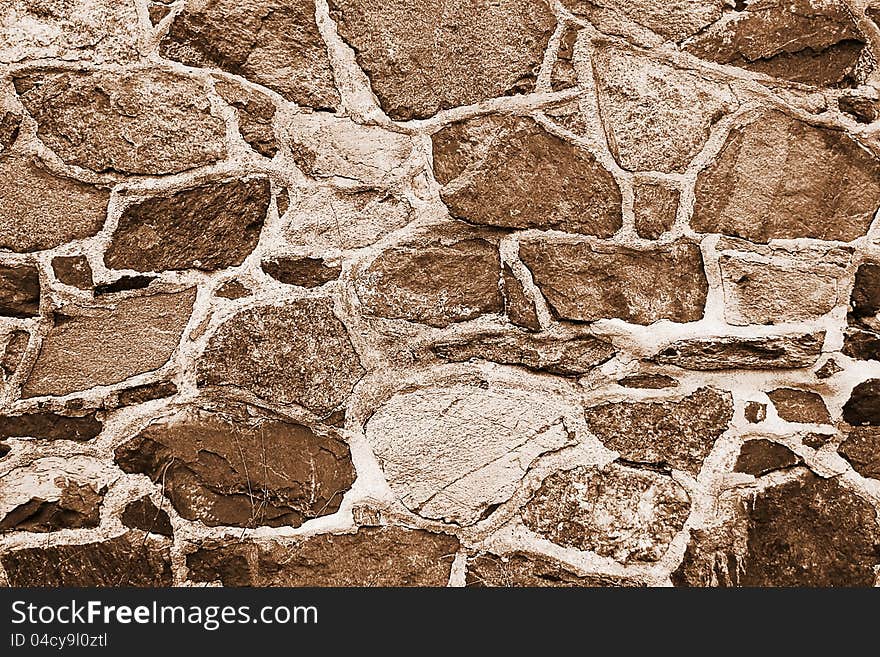 The fragment of ancient wall. Sepia color tone.