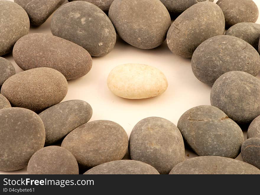 Closup of white stone surrounded by grey stones