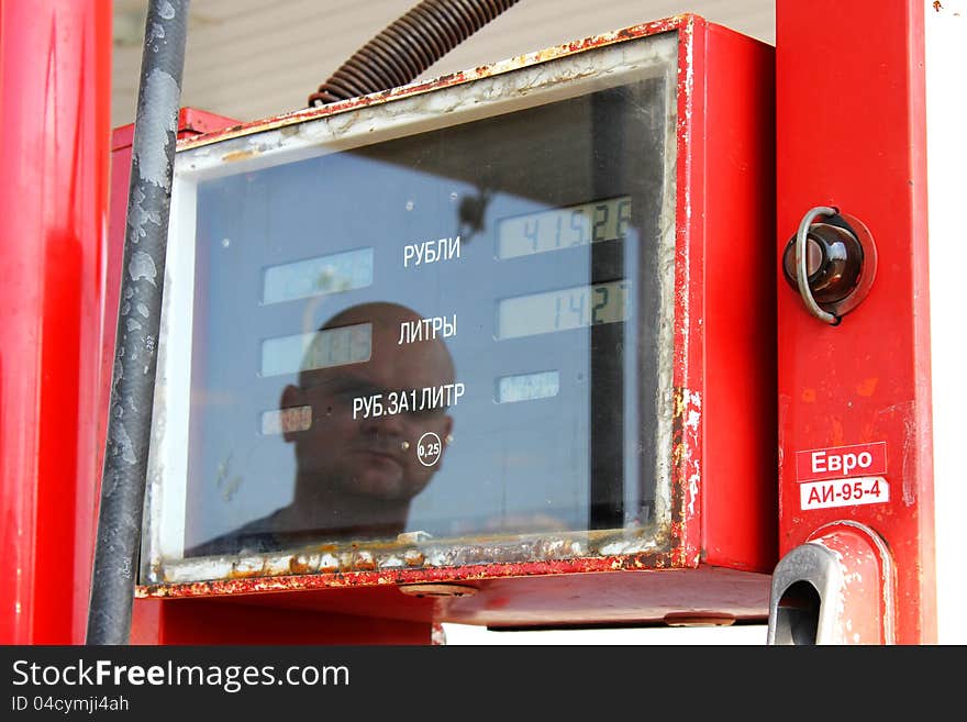 The gas station makes car filling by gasoline. The gas station makes car filling by gasoline