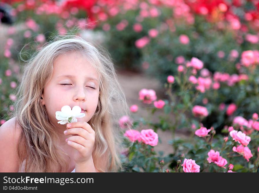 Girl enjoys the smell of flowers. Girl enjoys the smell of flowers