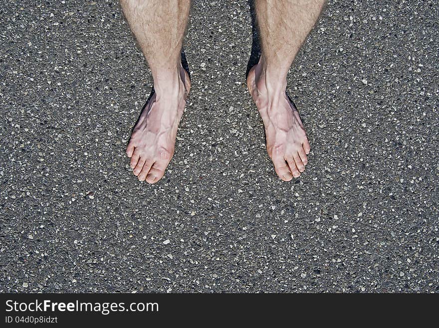 Close-up of male bare feet on cement horizontal shot. Close-up of male bare feet on cement horizontal shot