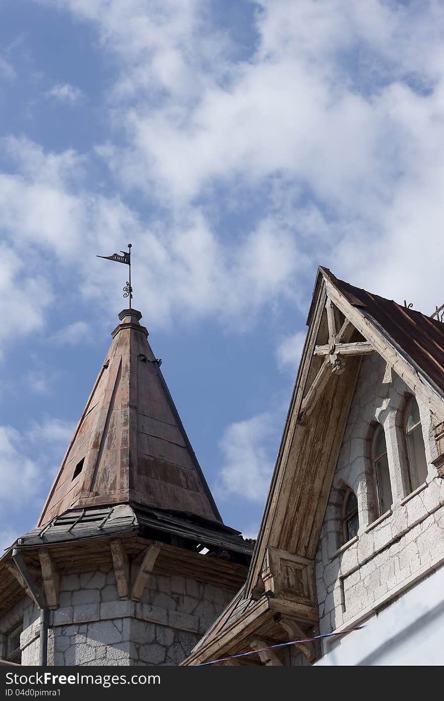 The ancient building in Simeiz against the blue sky with clouds