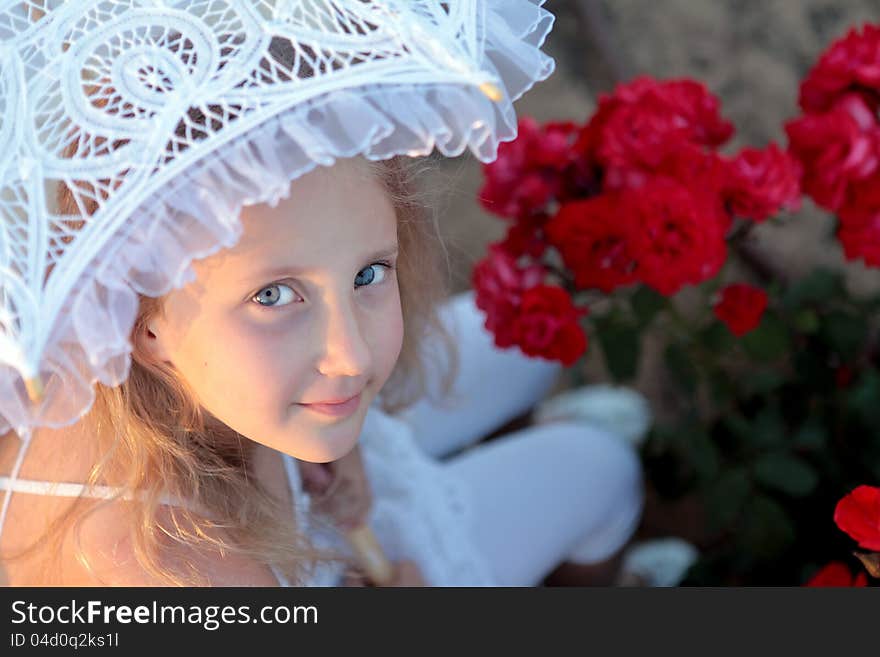 Girl looks out from under the lace parasol