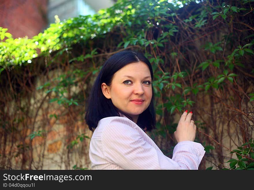 Brunette on a background of climbing plants day