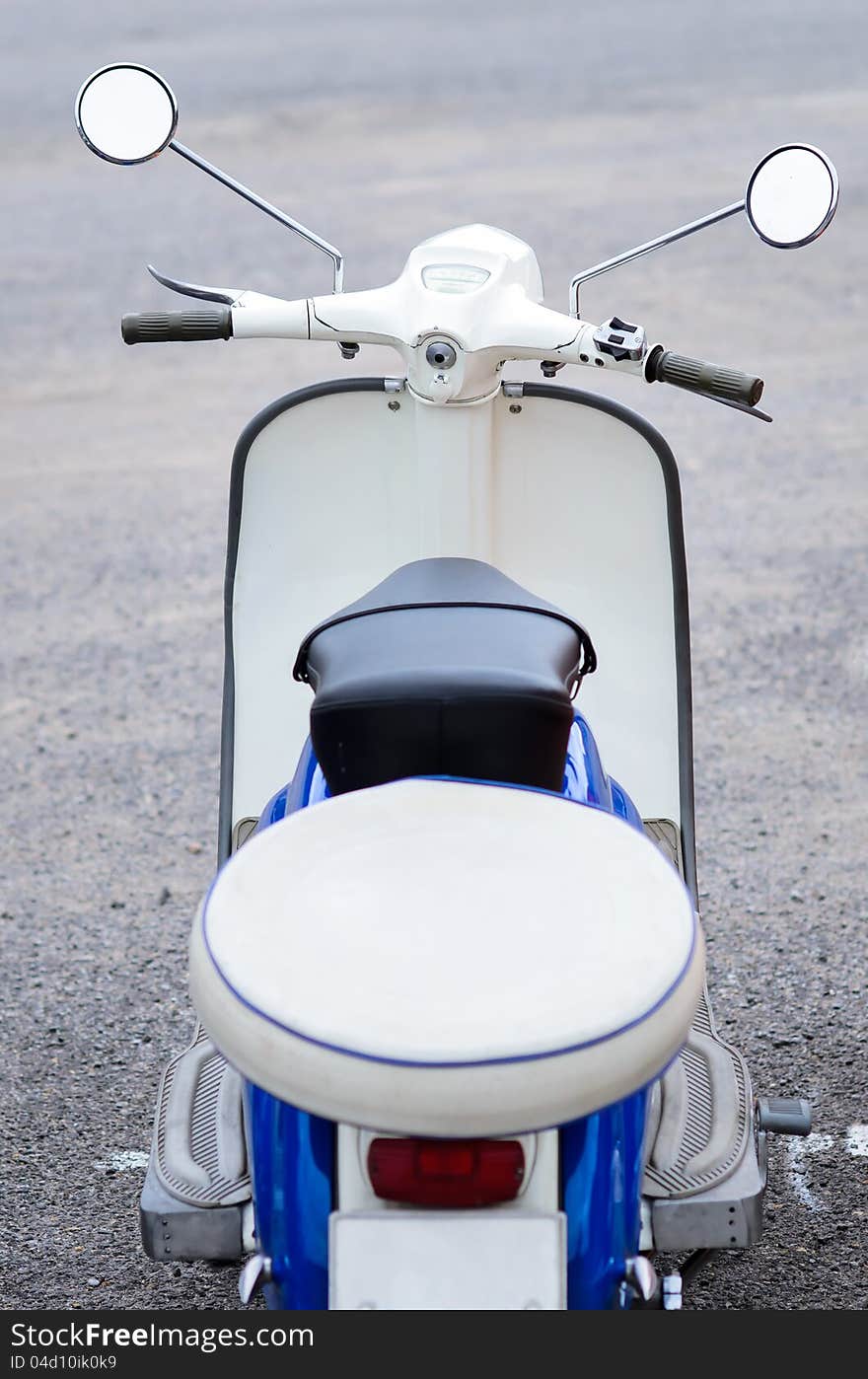 White vintage oldtimer scooter from behind. White vintage oldtimer scooter from behind.