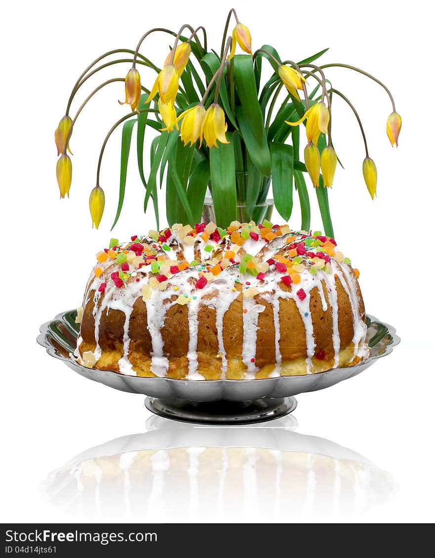 The composition of the biscuit cake and yellow tulips. The composition of the biscuit cake and yellow tulips