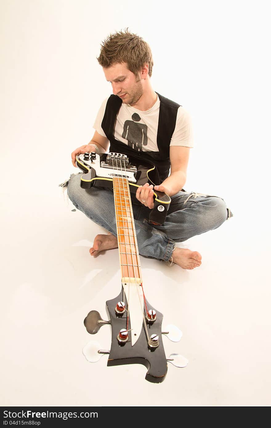 Young guy with a guitar playing rock and roll. Young guy with a guitar playing rock and roll