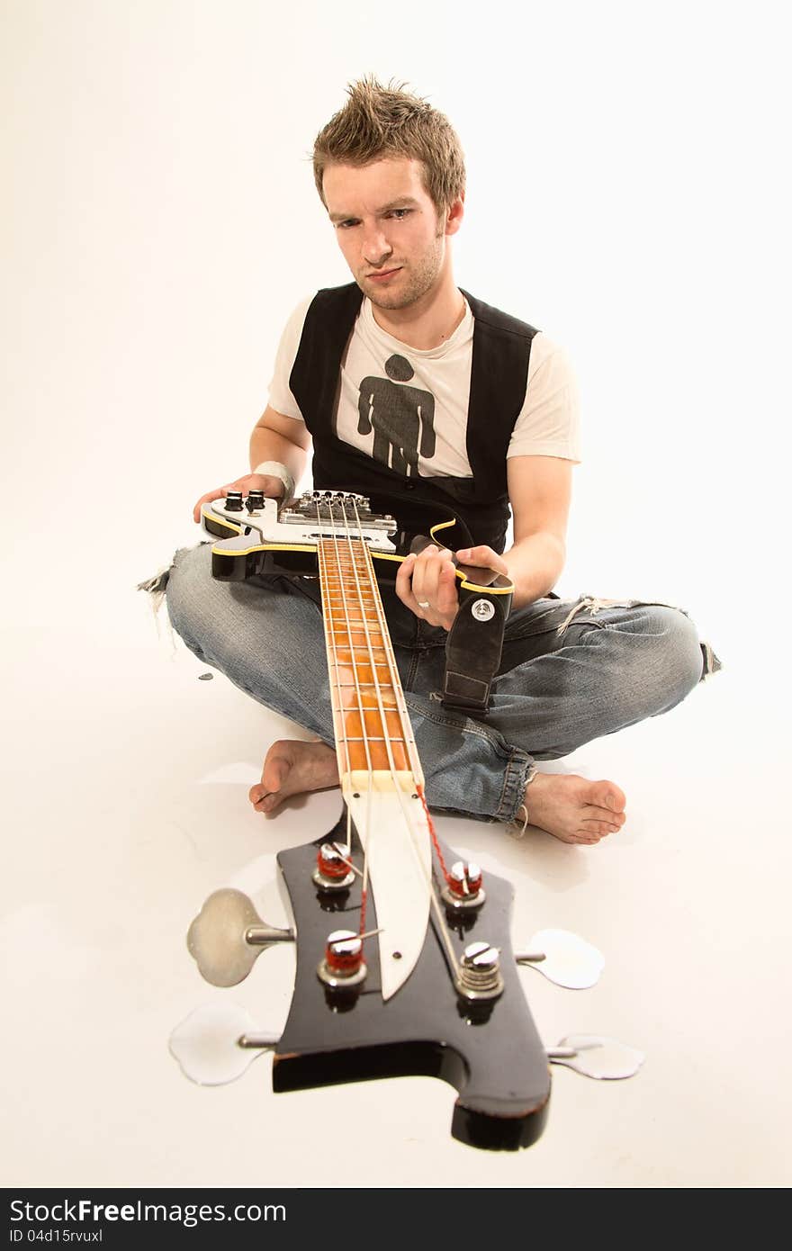 Young guy with a guitar playing rock and roll. Young guy with a guitar playing rock and roll