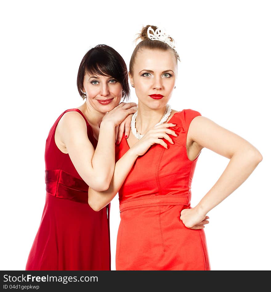 Portrait of two happy, smiling girls looking against each other on a white background