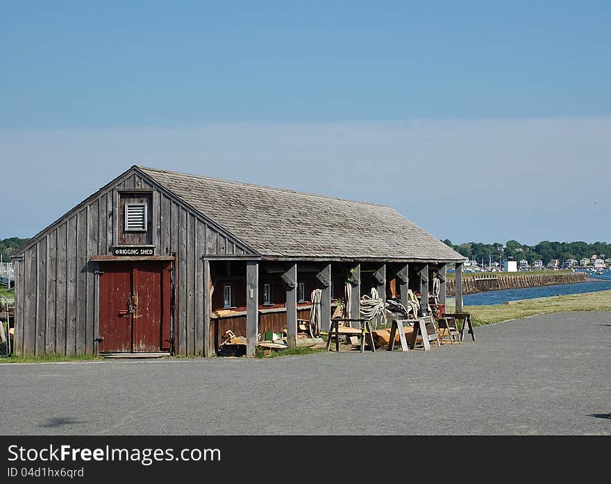 The historical rigging shed of the wharf with dark red doors, Salem harbor, MA. The historical rigging shed of the wharf with dark red doors, Salem harbor, MA