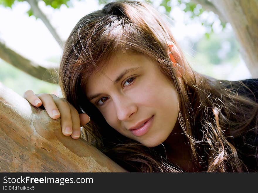 Woman Leaning on Tree Branch