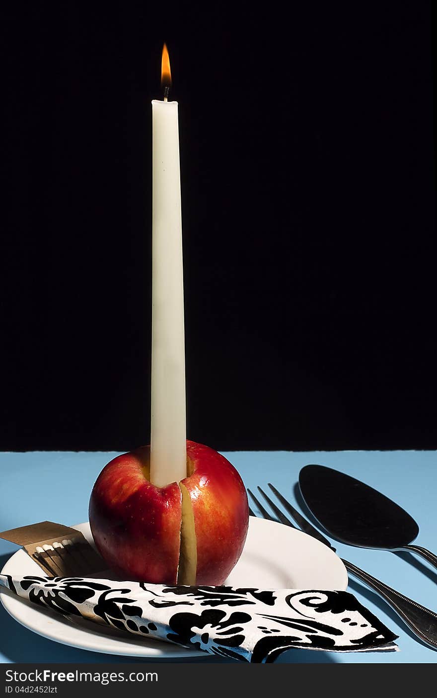 Concept, candle apple with serving utensils (Candy Apple Concept)