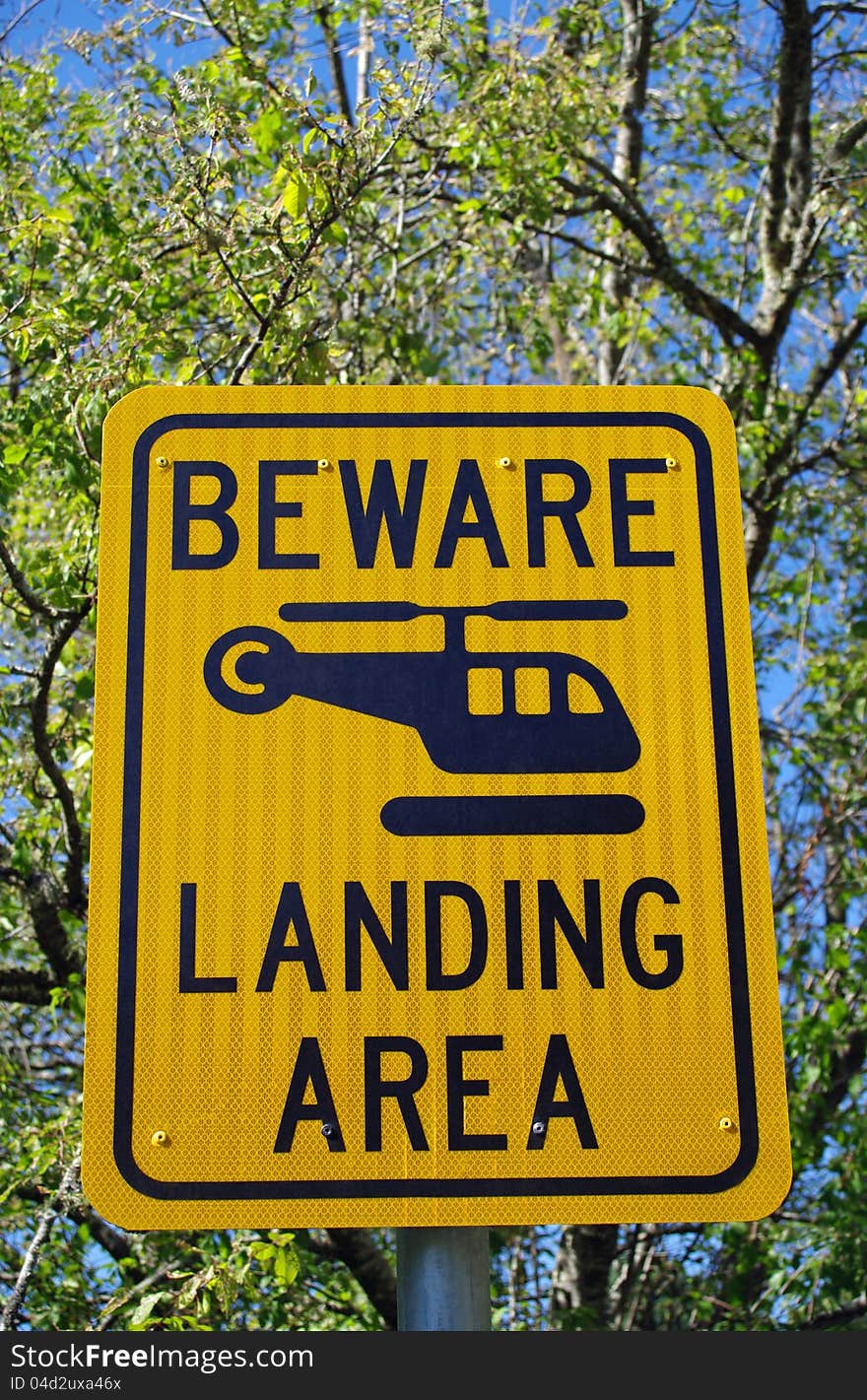 Yellow warning sign for helicopter landing area. Yellow warning sign for helicopter landing area