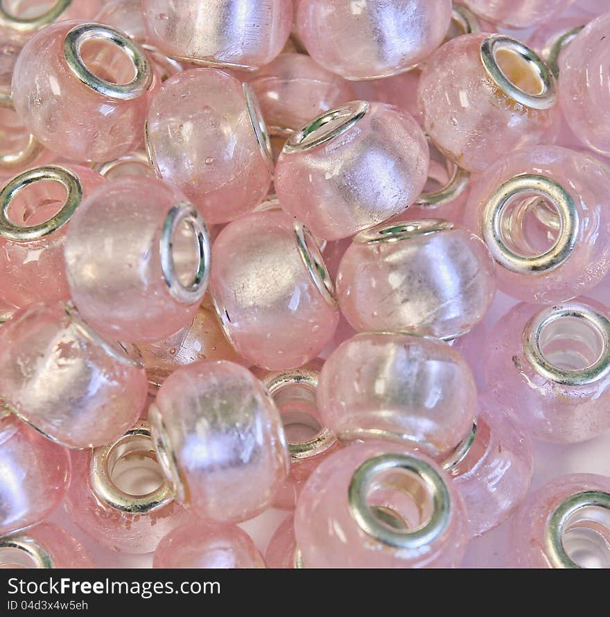 A grouping of pink foil glass beads for jewelry making or for art & crafts.