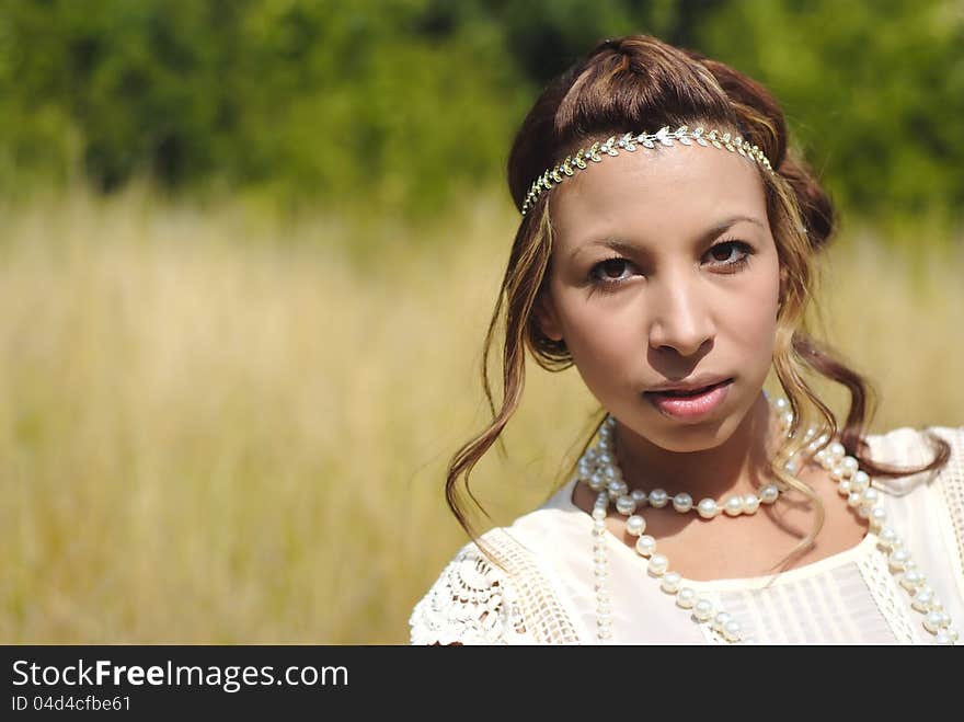 A beautiful head and shoulder shot. Olive skinned beauty out in the meadows. A beautiful head and shoulder shot. Olive skinned beauty out in the meadows.