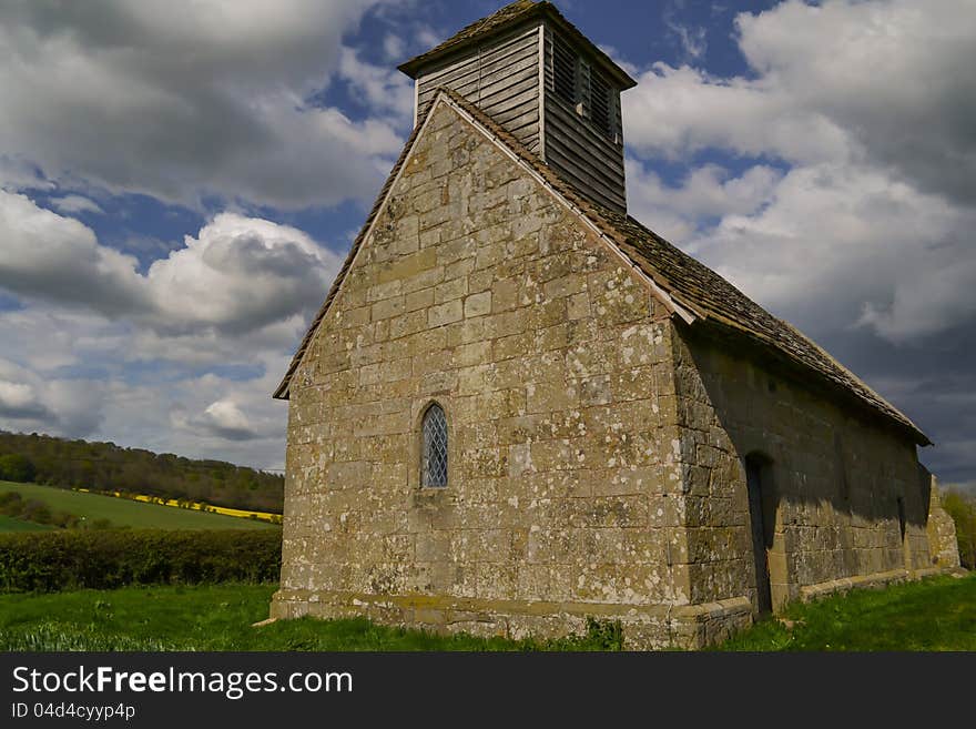 An ancient English chapel built by the Normans still standing proud in an English country field