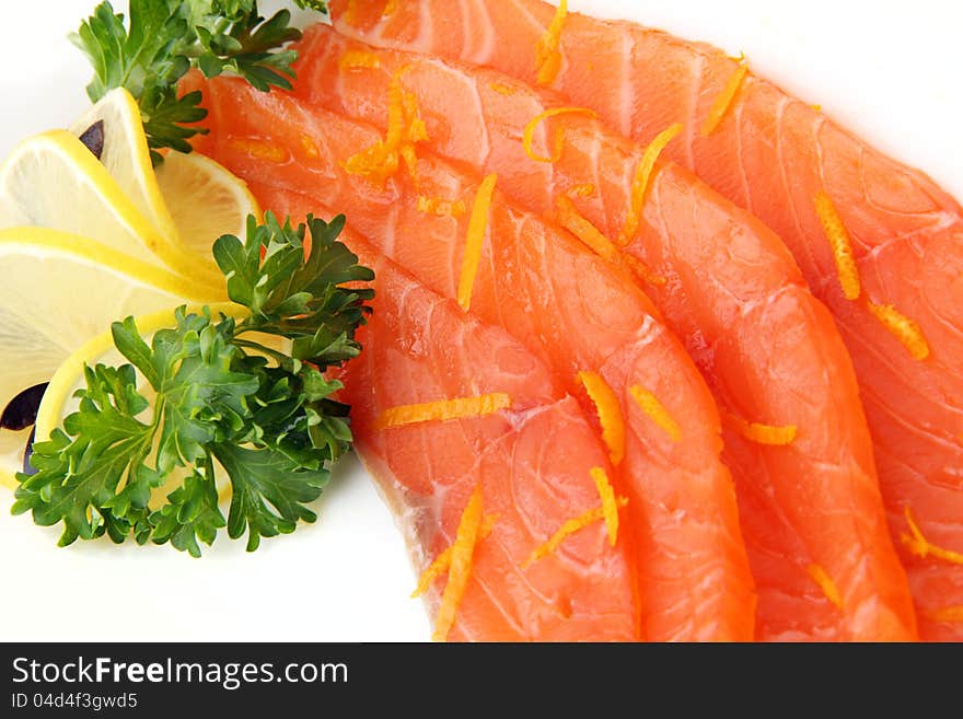 Slices of salmon with lemon on white background close up. Slices of salmon with lemon on white background close up