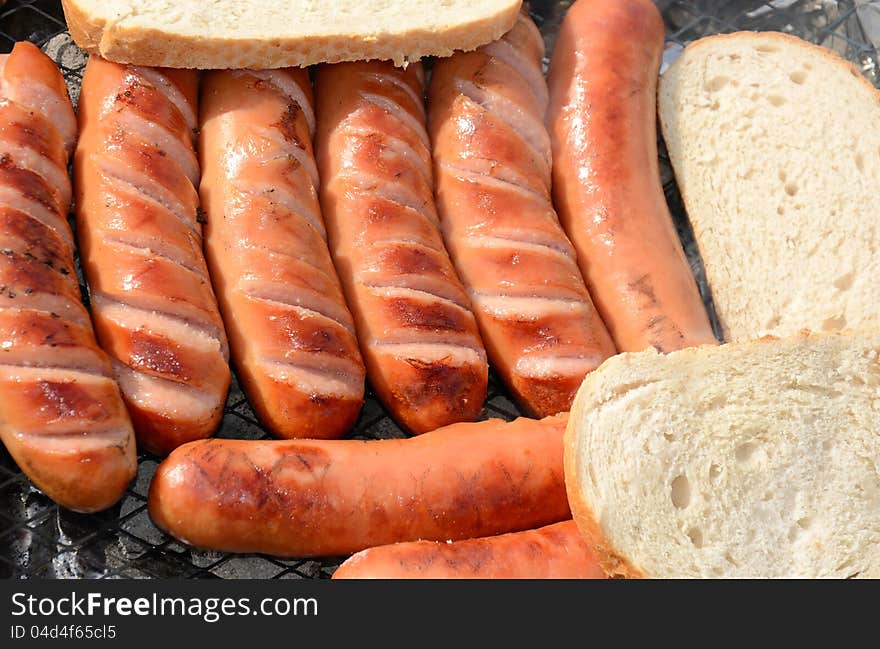 Closeup for grilled sausages with bread. Closeup for grilled sausages with bread