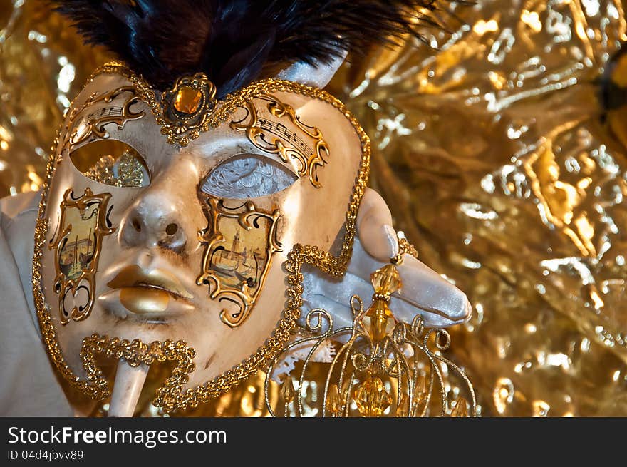 Carnival mask resting on his hand. Carnival mask resting on his hand